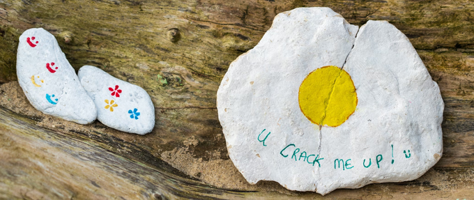 a rock with a crack in it painted like an egg with the words "u crack me up."